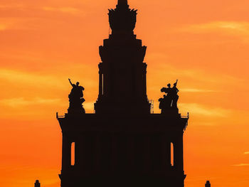 Low angle view of silhouette statue against sky during sunset