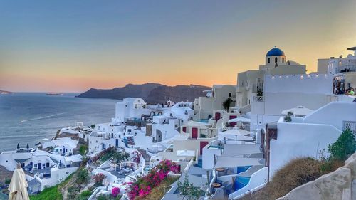 High angle view of townscape by sea against sky