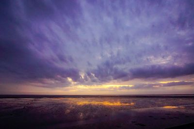 Scenic view of beach against sky during sunset