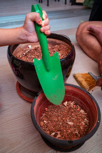 Gardening at home. transferring soil from one pot to another.