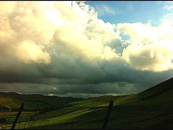 Scenic view of landscape against cloudy sky