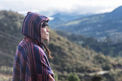 Rear view of woman standing against mountain