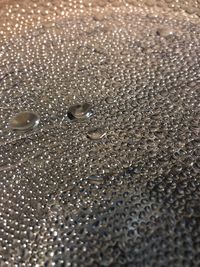 Full frame shot of water drops on metal