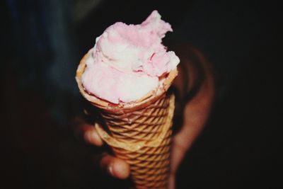 Close-up of ice cream cone against black background