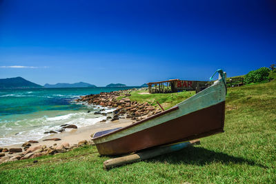 Scenic view of beach against blue sky