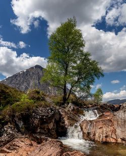 Scenic view of waterfall against sky