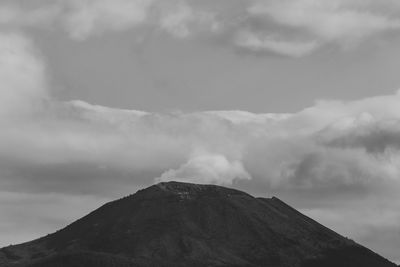 Low angle view of volcanic mountain against sky