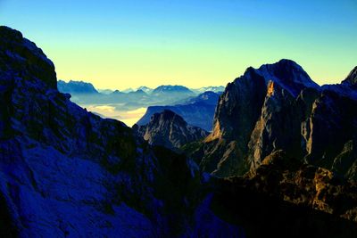 Panoramic view of mountains against blue sky