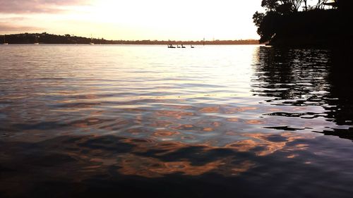 Scenic view of river at sunset