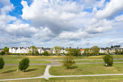 Park by buildings against sky in city