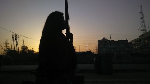 Silhouette of woman at sunset