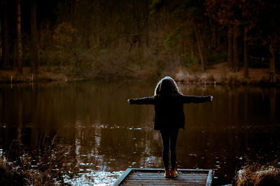 Woman on jetty by lake