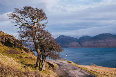 Scenic view of lake by mountains against sky