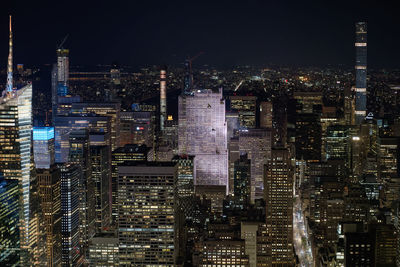 Illuminated cityscape against sky at night