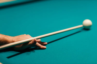 Cropped hand playing pool