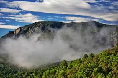 Scenic view of mountains against cloudy sky