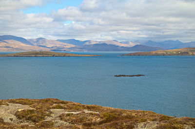 Scenic view of lake and mountains against sky