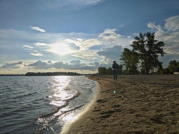 Man standing on beach against sky