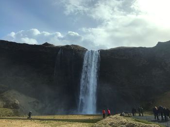 People against waterfall