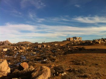 Built structure on landscape against sky