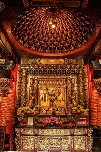 Low angle view of illuminated statue in temple