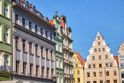 Low angle view of buildings against blue sky