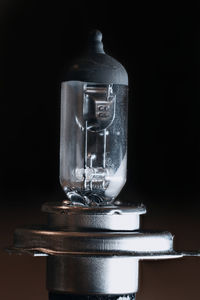 Close-up of light bulb against black background