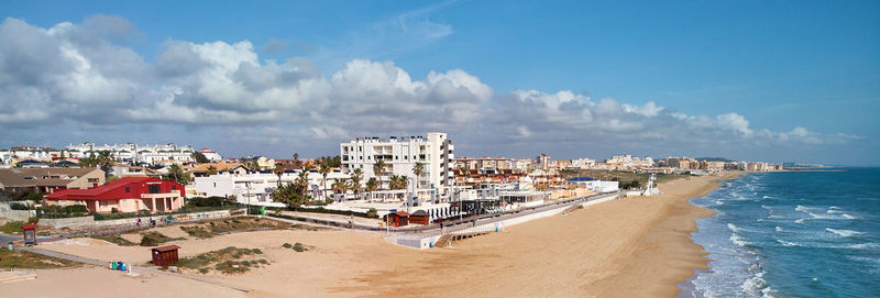 High angle view of beach and buildings against sky