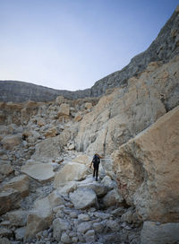 Low angle view of woman climbing on mountain