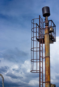 Low angle view of crane against sky