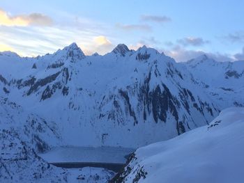 Scenic view of snow covered mountains against sky