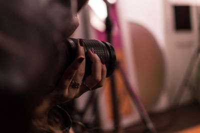 Cropped hand of woman photographing through camera