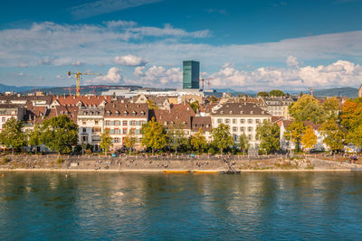 Buildings in city against cloudy sky