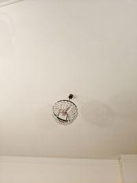 Low angle view of electric lamp on wall