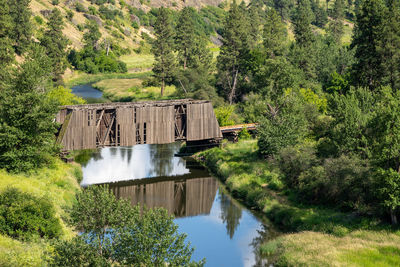 Built structure by lake against trees