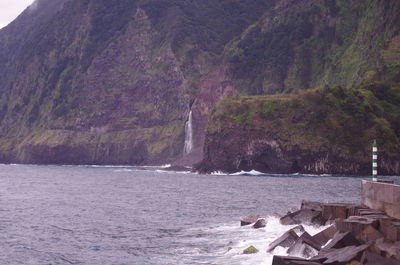 Scenic view of sea by mountain