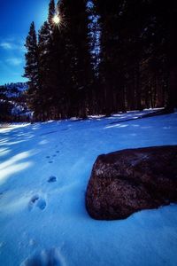 Scenic view of snow covered land against sky