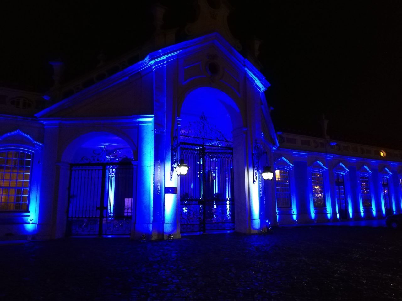 ILLUMINATED LIGHTING EQUIPMENT ON BUILDING AT NIGHT