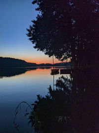 Scenic view of lake against sky at sunset