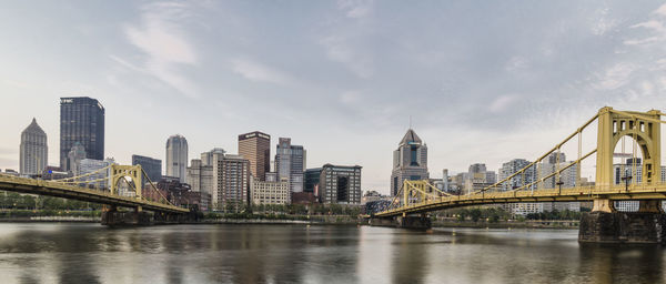 Bridge over river with city in background