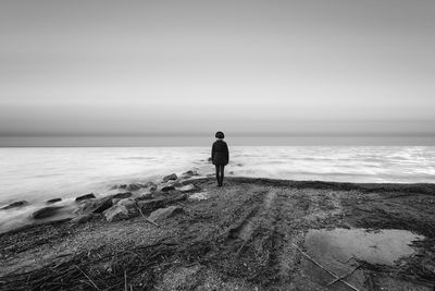 Rear view of man standing on beach