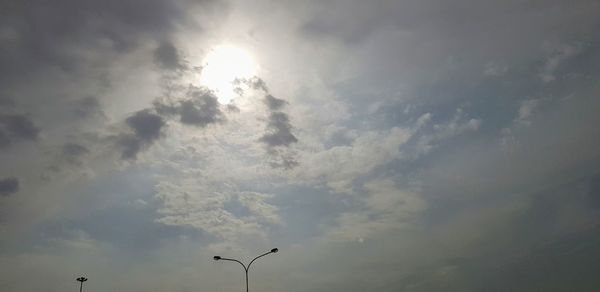 Low angle view of street light against bright sun