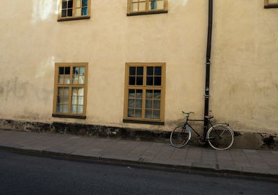 Bicycle against window in city