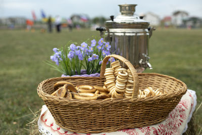 Russian treats. sweetness from flour. basket of dry stems. steel kettle. folk tradition. 