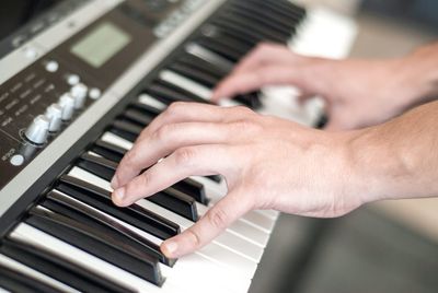 Midsection of man playing piano