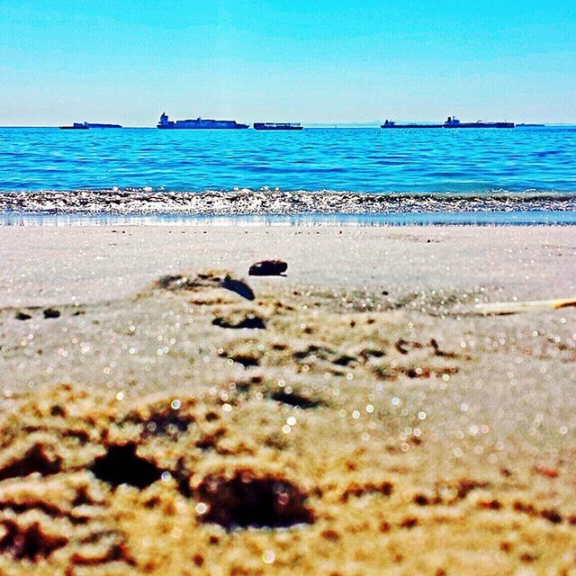 sea, beach, water, horizon over water, shore, sand, tranquility, tranquil scene, scenics, blue, beauty in nature, clear sky, nature, sky, idyllic, coastline, calm, incidental people, wave, outdoors