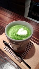 High angle view of green tea cup on table