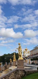 Statue of historical building against cloudy sky