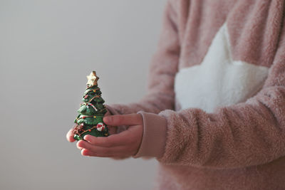 Close-up of hand holding christmas tree