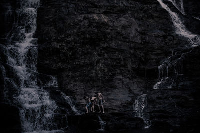 High angle view of two people standing in cave